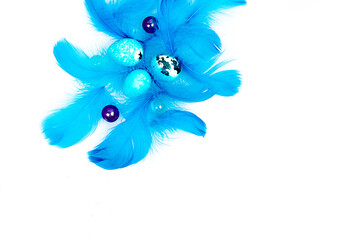 Blue Easter eggs and small fluffy blue feathers randomly scattered
