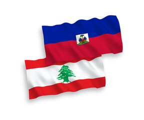 National vector fabric wave flags of Republic of Haiti and Lebanon isolated on white background. 1 to 2 proportion.