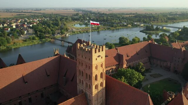 Malbork,Poland.Aerial 4K video from drone to Medieval Malbork ( Zamek w Maborku, Ordensburg Marienburg ),castle in Poland fortress of the Teutonic Knights at the Nogat river in sunrise light.(Series)