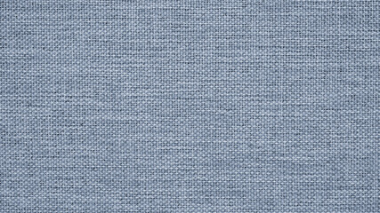 Fototapeta na wymiar Close-up of gray-blue woven surface. The texture is similar to len. Abstract background from fabric. Textured braided generic gray backdrop. Macro