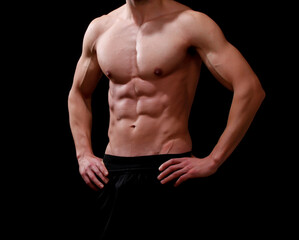 Fototapeta na wymiar Muscular male torso - isolated fitness body of men black background