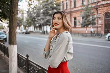 cheerful woman in a red skirt city walk fun leisure summer