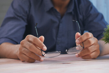 Close up of man hand holding old eyeglass