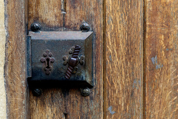 Old wooden door entrance with an antique door handle and lock