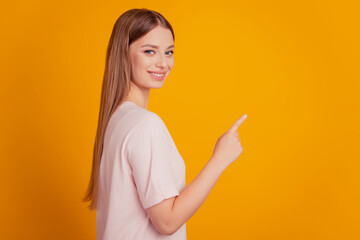 Portrait of adviser lady forefinger indicate empty space on yellow background