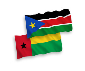 National vector fabric wave flags of Republic of Guinea Bissau and Republic of South Sudan isolated on white background. 1 to 2 proportion.