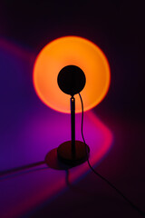 Sunset projector lamp with yellow light on dark background.