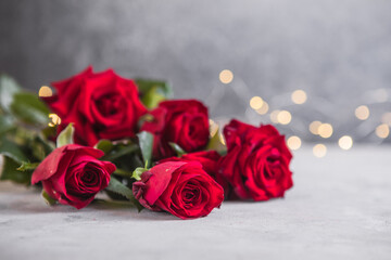composition with beautiful red roses on light background, space for text. Valentine's Day celebration