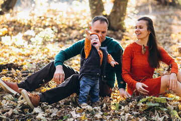Family with their little son in an autumn park