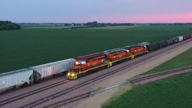Rotating aerial shot of freight train slowing down