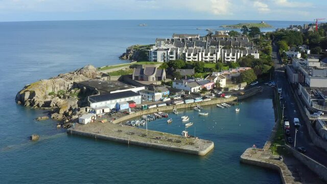 Bullock Harbour, Dalkey, Dublin, Ireland, September 2021. Drone slowly ascends and tilts down looking into the harbour from the northwest with Dalkey Island in the background.