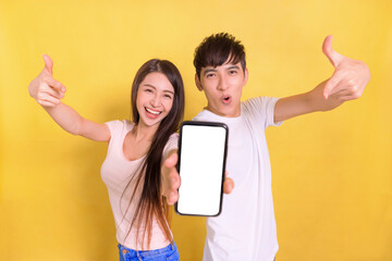 Excited Young  couple pointing at blank  smartphone screen
