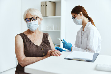elderly woman wearing a medical mask in the hospital for vaccinations covid-19 passport