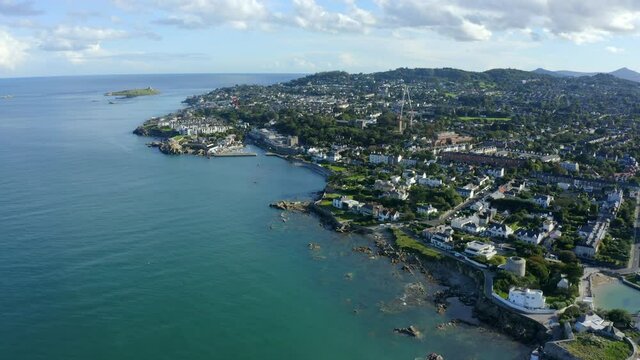 Bullock Harbour, Dalkey, Dublin, Ireland, September 2021. Drone slowly pushes along the coastline from Sandycove with Dalkey Island and Killiney Hill in the background.