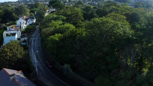 Bullock Harbour, Dalkey, Dublin, Ireland, September 2021. Drone pulls backwards from Ulverton road across the harbour passing boats and quays ending with a view from across the water.