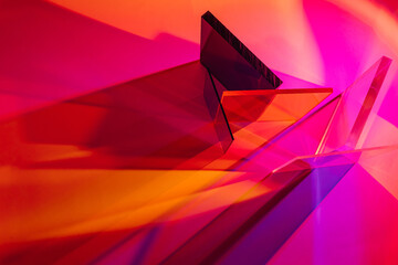 Multicolored glass on colorful gradient background. The light travels through different acrylic...
