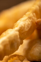 Fried breadsticks with salt, close-up, selective focus.