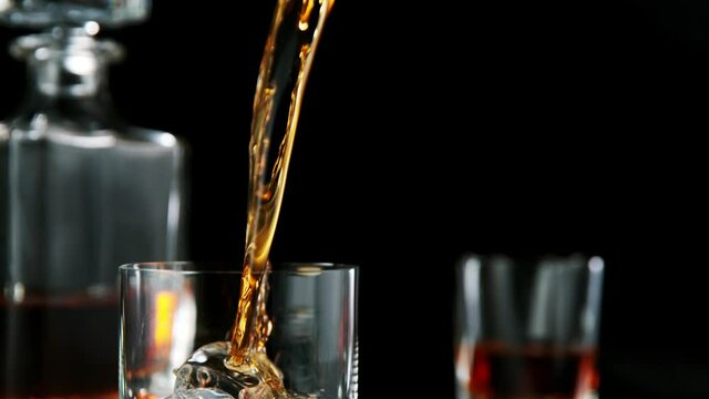 Super slow motion of pouring whiskey or rum with camera motion. Filmed on high speed cinema camera, 1000 fps.