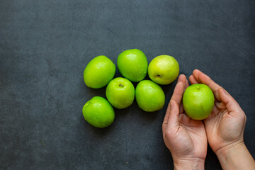 Fresh green jujube fruit isolated on dark background