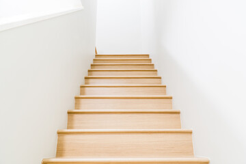 Fototapeta na wymiar Brown wooden stairs in a modern house from below.