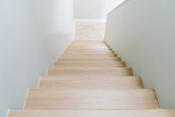 Brown wooden stairs in a modern house from above.