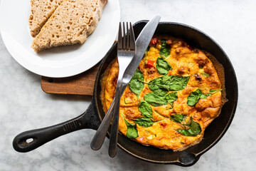 Delicious omelet with fresh lettuce and tomatoes served in a pan for an healthy full breakfast.