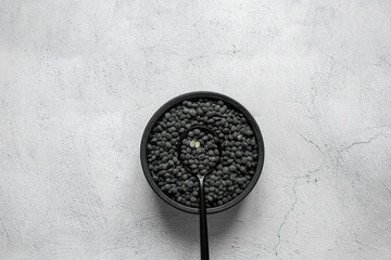 Black beans in bowl on white background.