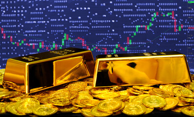 Gold bullion on at computer trading chart background