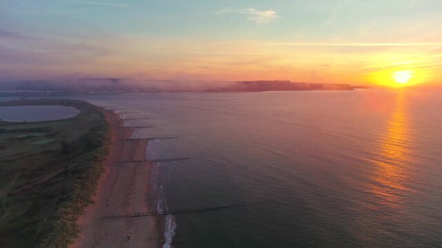 Sunrise over Exmouth and Dawlish Warren Beach from a drone, Devon, England, Europe
