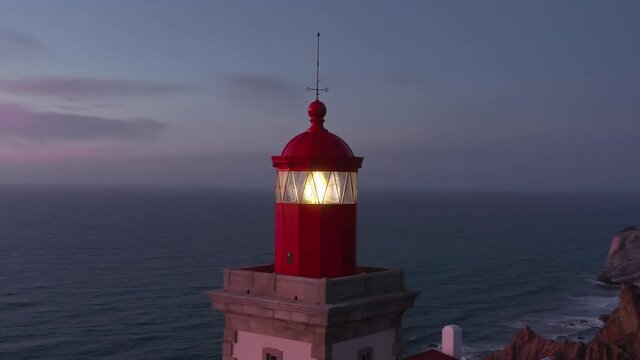 The Cabo da Roca Lighthouse, Sintra, Portugal, Europe. Calm and magical sunset at the picturesque cape. Aerial footage of breathtaking natural scenery with operating beacon. High quality 4k footage