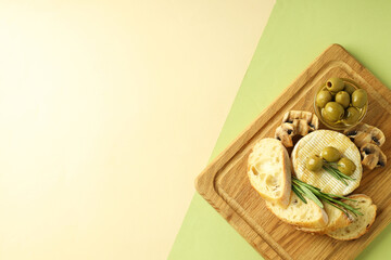 Concept of tasty food with grilled camembert on two tone background