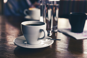 black coffee in a white cup on the table