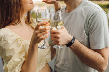 Pleasant moments of a couple's date with wine in glass glasses. Happiness and serenity. Rest and enjoyment.Wonderful moments of life. Super day. Romantic relationships.