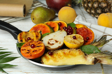 Fototapeta na wymiar Concept of tasty food with grilled fruits on white wooden table