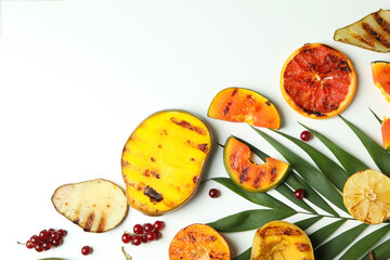 Concept of tasty food with grilled fruits on white background