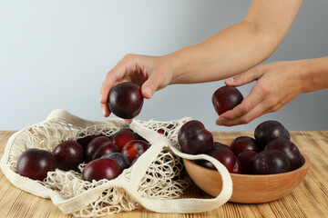 Concept of fruit with plums on wooden table