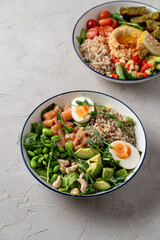 Hummus buddha bowls with quinoa and hard boiled egg, vegetarian restaurant menu, modern simple concept