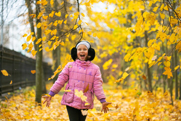 child playing with yellow flowers