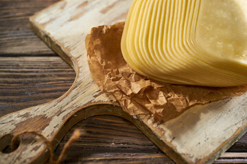 Sliced pieces of cheese on rustic wooden background, cheese sandwiches