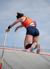 High School girls competing in pole vault at a track and field meet