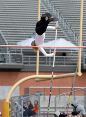 High School girls competing in pole vault at a track and field meet