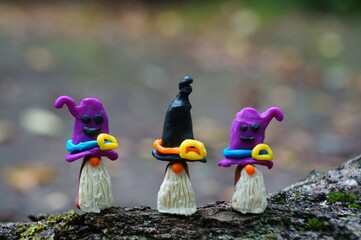 Figurines of three fairy-tale dwarfs made of plasticine. The concept of Halloween.