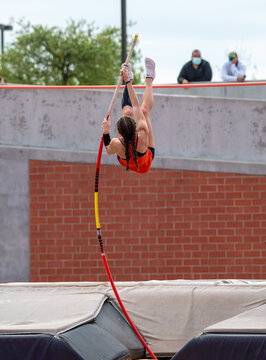 High School girls competing in pole vault at a track and field meet
