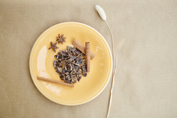 Plant-based alternative - natural carob. Organic antioxidants and protein. Copy space. Decoration with cinnamon sticks and dried cloves. Top view