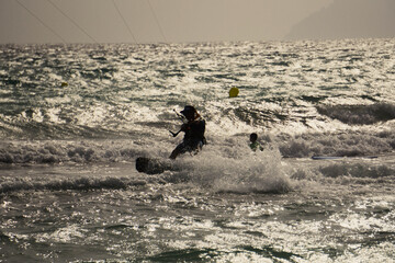 Silhouette of a kitesurfer close to the beach