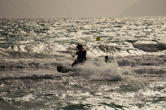 Silhouette of a kitesurfer close to the beach