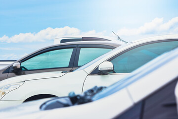 The car is parked in the parking lot with a cloud and blue sky