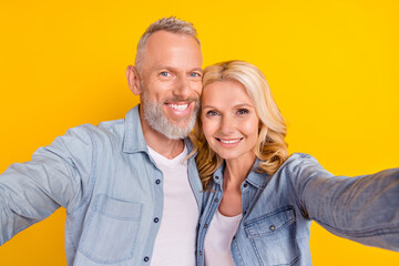 Photo of old couple wife husband make selfie good mood smile enjoy cool isolated on yellow color background