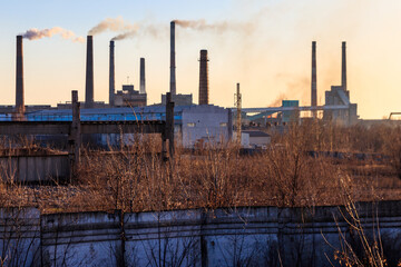 Fototapeta na wymiar View of old factory with pipes with smoke. Air pollution, environmental damage