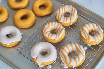 Preparation of glazed donuts in traditional pastry.